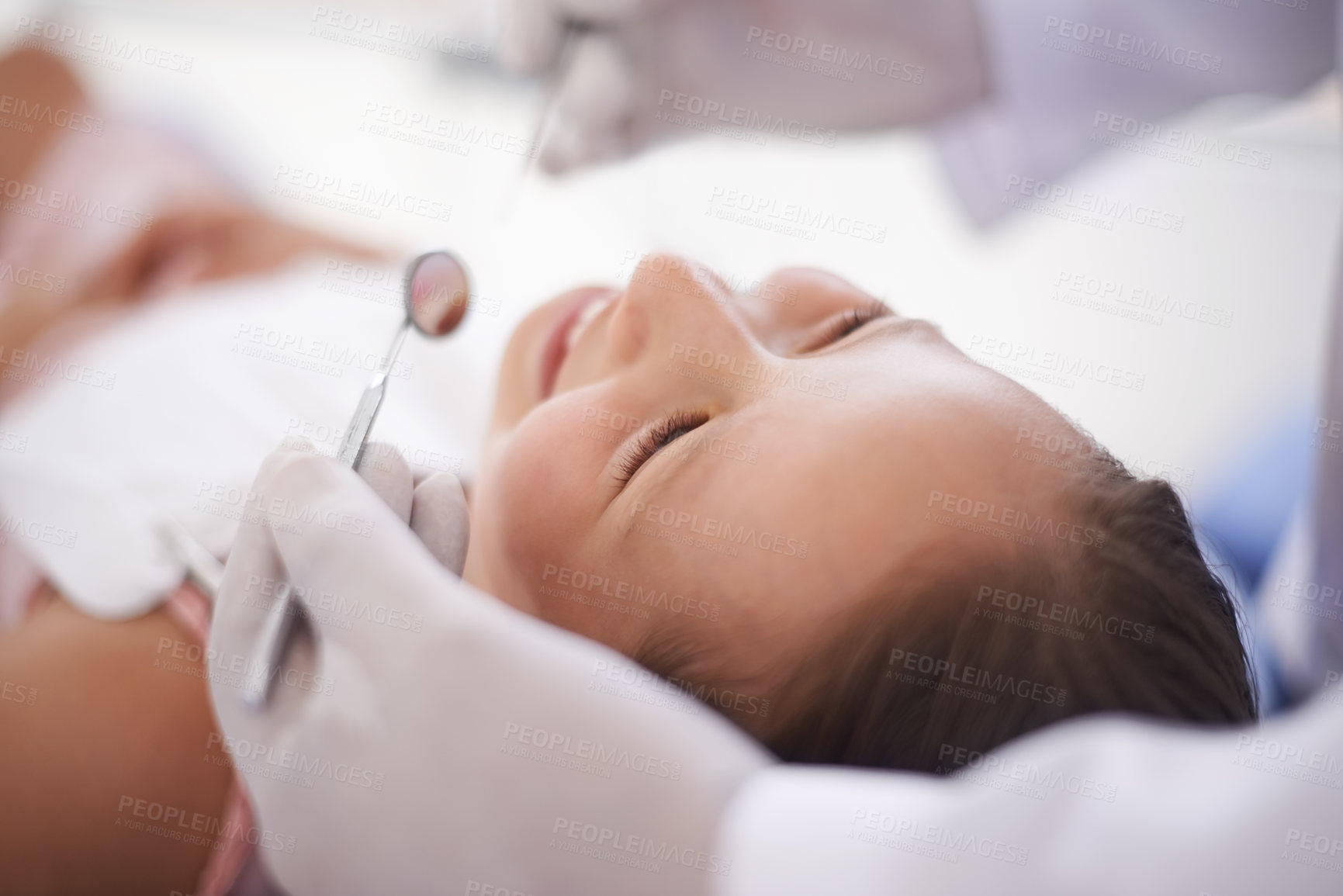 Buy stock photo Cropped shot of a little girl getting her teeth checked