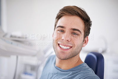 Buy stock photo Portrait of a young, smiling man sitting in a dentist's chair