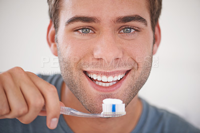 Buy stock photo Cropped shot of a man brushing his teeth