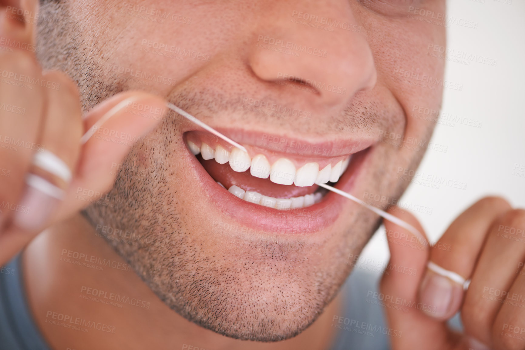 Buy stock photo Cropped shot of a man flossing his teeth