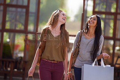 Buy stock photo Two attractive young woman with their shopping bags after a day of retail therapy