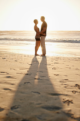Buy stock photo Man, woman and hug at beach for sunset for holiday happiness together, honeymoon or marriage. Couple, evening and embrace for commitment or Miami weekend for love travel, vacation or relationship