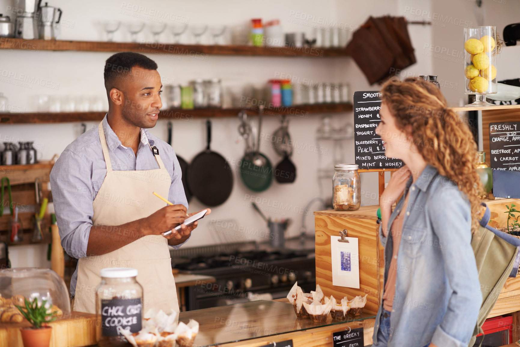 Buy stock photo Woman, cafe and barista with order at counter for purchase, shopping and lunch at coffee shop. Female person, small business and waiter with notepad for discussion, writing and customer service