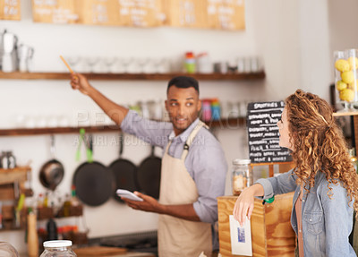 Buy stock photo Woman, cafe and barista with pointing at menu for customer, purchase and decision in coffee shop. Waiter, small business and lady in restaurant with thinking, idea and choice for lunch order