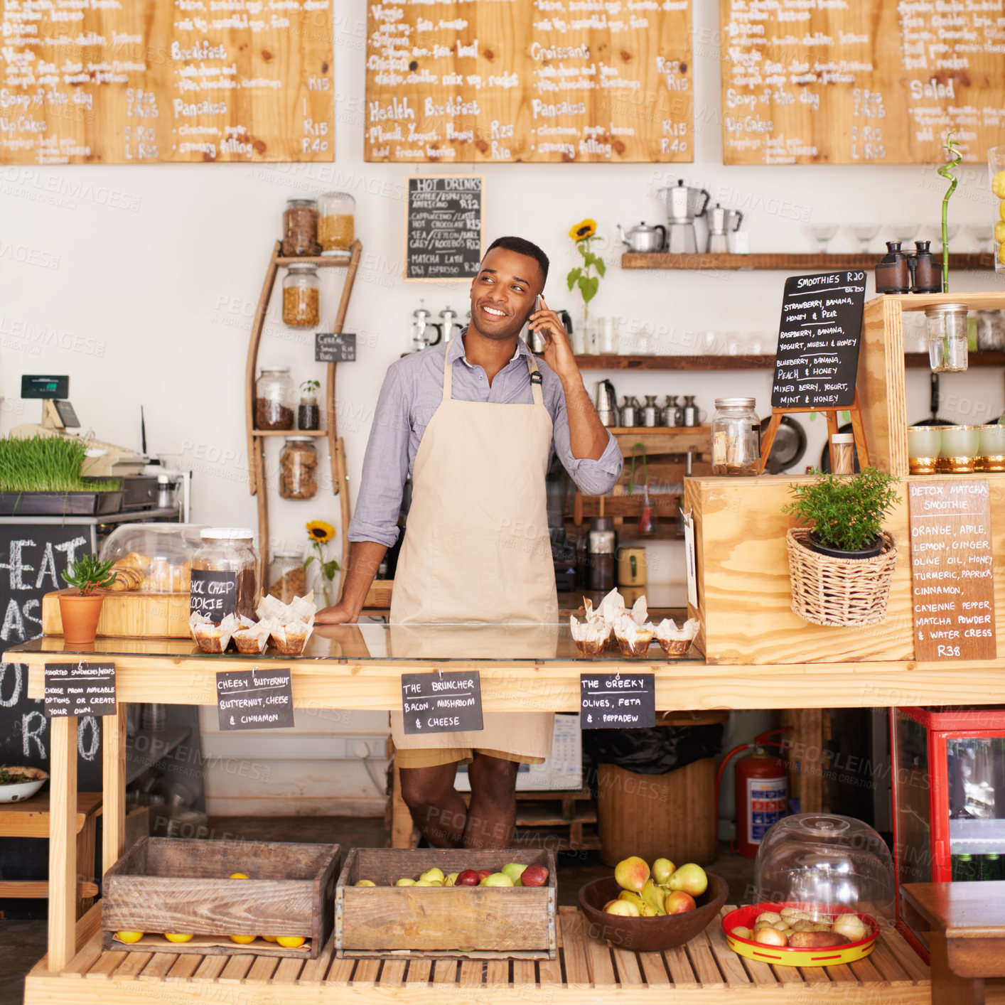 Buy stock photo Thinking, smile and phone call with black man in coffee shop for communication, networking or service. Cafe, restaurant and small business with happy young store owner or vendor working in bakery