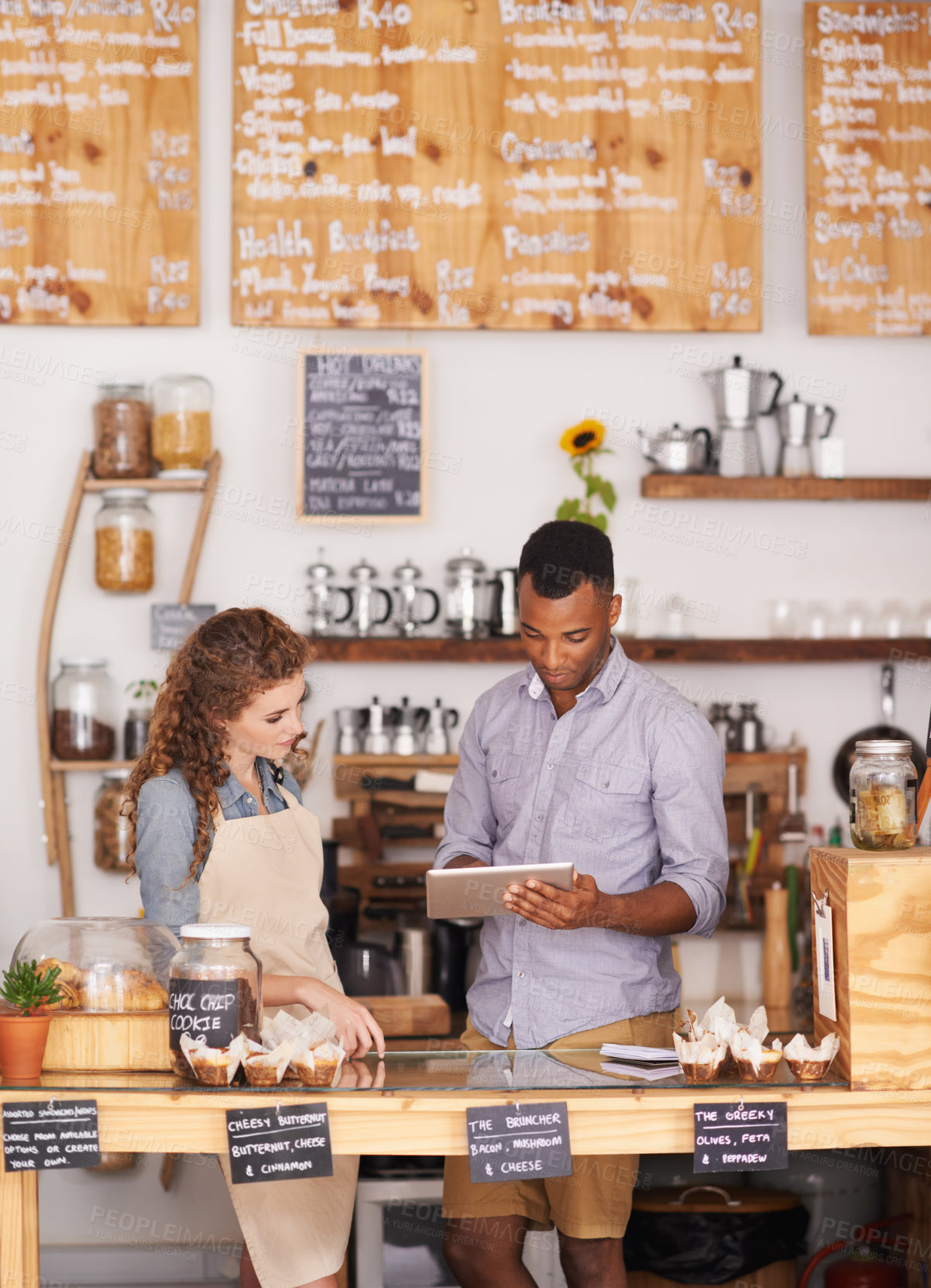 Buy stock photo Small business, talking and employees with a tablet, digital planning or share ideas for profit growth. Black man, woman or coworkers with technology, store or happiness with communication at a store