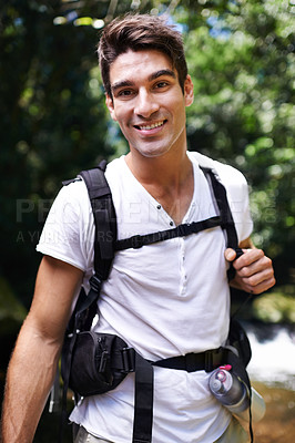Buy stock photo Man, portrait and hiking in tropical forest with smile for adventure, holiday or outdoor in summer by river. Person, happy and backpack for trekking, walk or journey in nature on vacation in Colombia