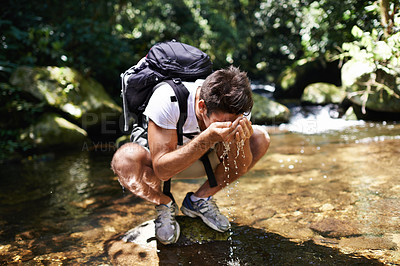 Buy stock photo Water, splash or man hiking in nature or wilderness for cleaning face or trekking adventure. River, relax or male hiker on break walking in a natural park or woods for exercise or wellness by a lake