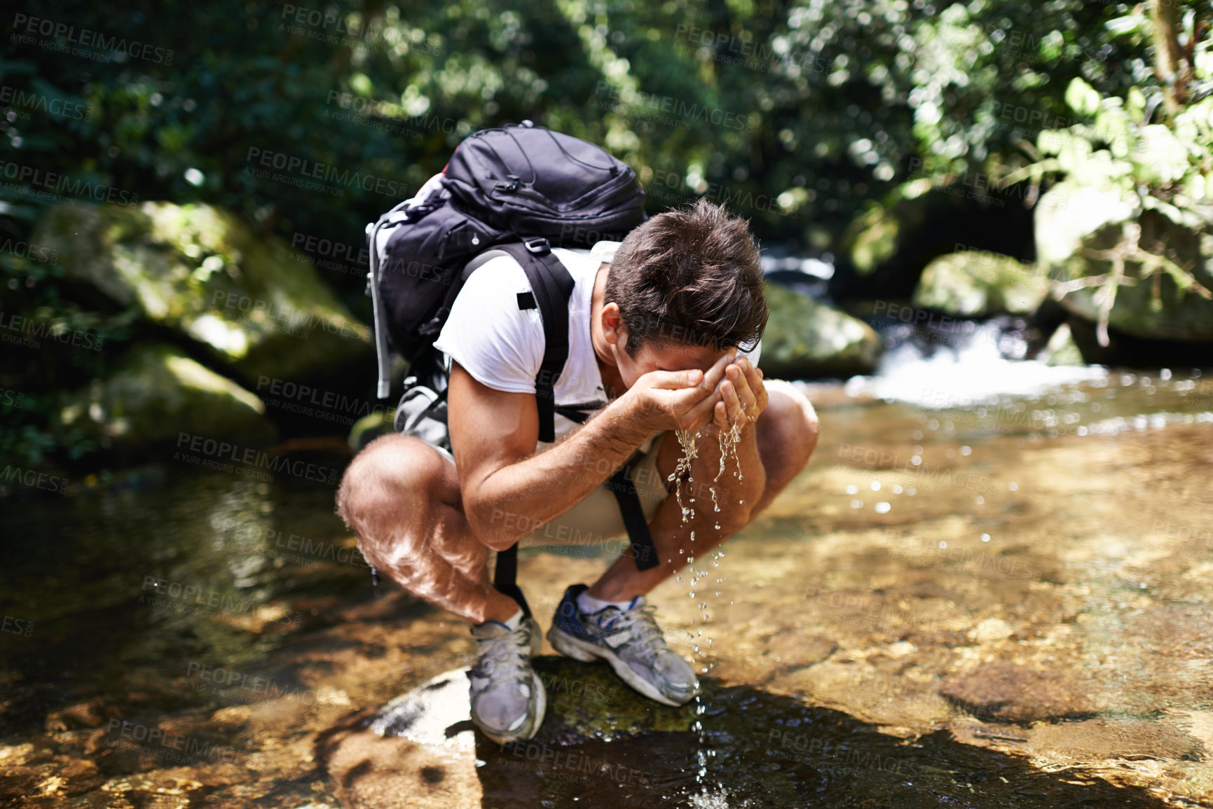 Buy stock photo Water, splash or man hiking in nature or wilderness for cleaning face or trekking adventure. River, relax or male hiker on break walking in a natural park or woods for exercise or wellness by a lake