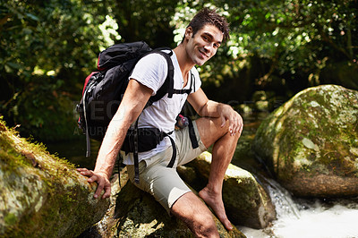 Buy stock photo Man, portrait and river for hiking in rainforest with smile for adventure, holiday and backpack in summer. Person, happy and bag for trekking, outdoor and journey on rocks for vacation in Colombia