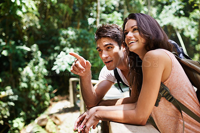 Buy stock photo Hiking, talk or happy couple pointing in nature, forest or park on a trekking adventure on holiday. Man, woman or romantic people in woods for travel or journey for care, love or wellness on vacation