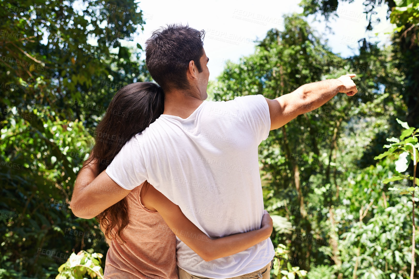 Buy stock photo Pointing, hug or back of couple in nature for journey on outdoor trekking adventure or vacation. Man, woman or romantic people on fun holiday trip to relax in forest for exercise, travel or wellness