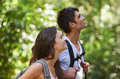 Buy stock photo Couple, adventure and backpack for hiking in rainforest with smile for thinking, holiday or search in summer. Man, woman and bag for trekking, direction or journey in nature for  vacation in Colombia