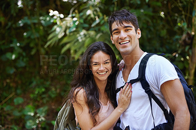 Buy stock photo Happy couple, portrait and hiking with backpack in nature for adventure or outdoor journey together. Face of young man, woman or hiker with smile, hug and bag for bonding, trekking or walk in forest