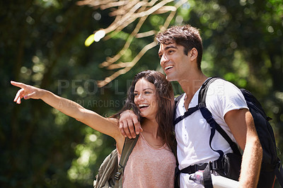 Buy stock photo Couple, point and happy for hiking in jungle with smile for thinking, holiday and ideas on path. Man, woman and bag for trekking, direction and search in rainforest with guide at location in Colombia