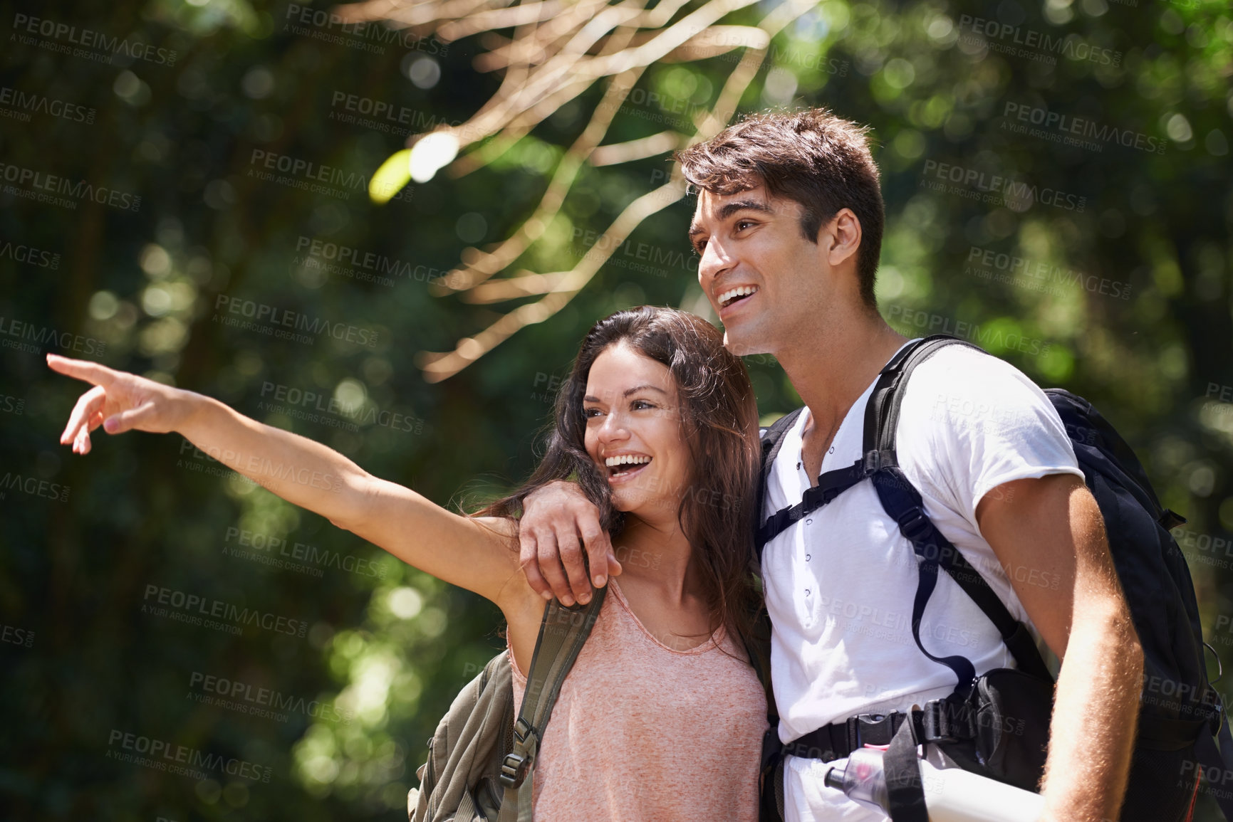 Buy stock photo Couple, point and happy for hiking in jungle with smile for thinking, holiday and ideas on path. Man, woman and bag for trekking, direction and search in rainforest with guide at location in Colombia