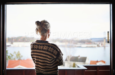 Buy stock photo Rearview shot of woman looking out the window