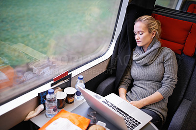 Buy stock photo Woman, train and sleep with travel or laptop or relax commute or journey tired, window or transportation. Female person, railroad and seat resting in Canada as passenger for comfort, internet or trip