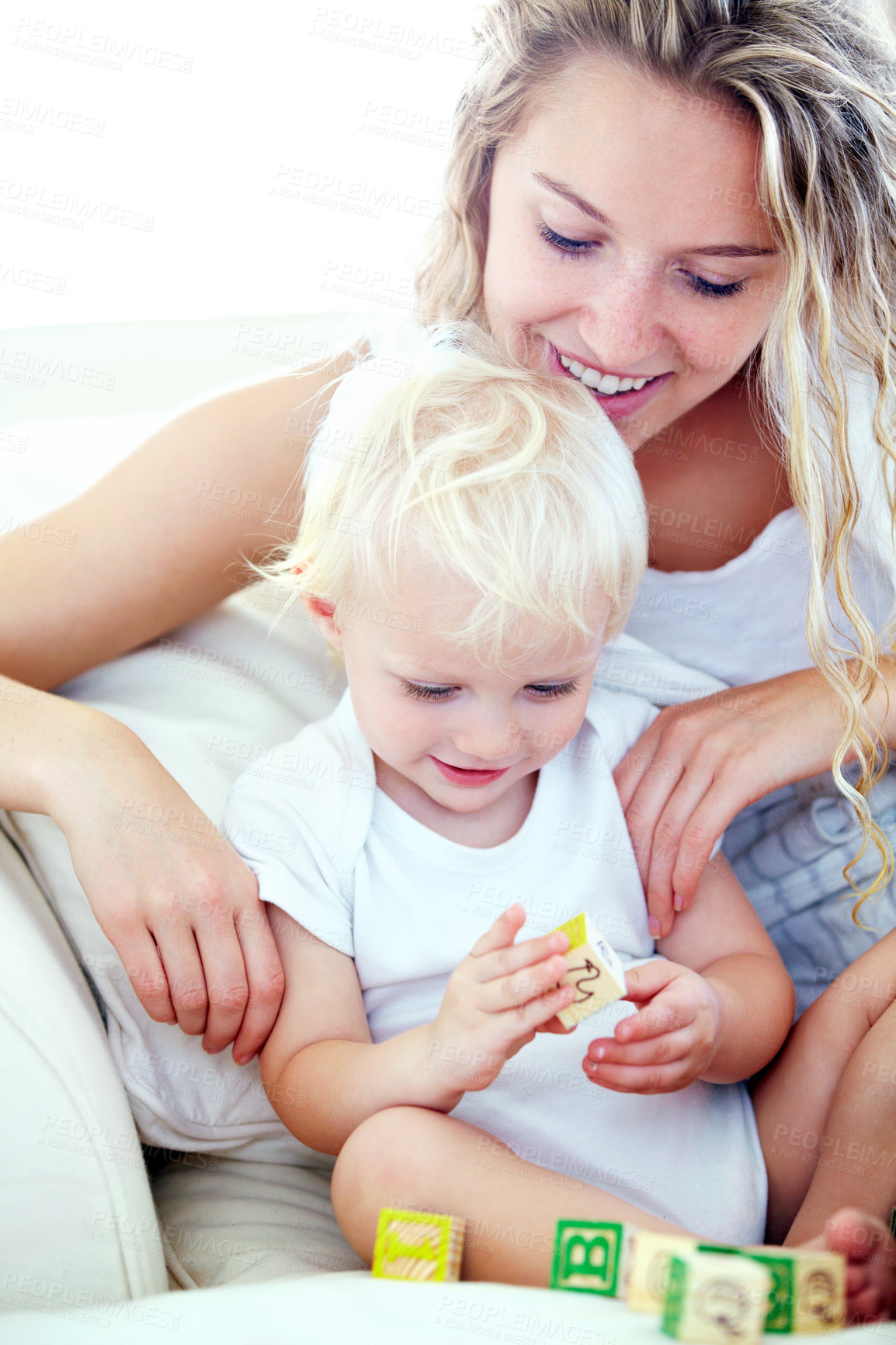 Buy stock photo Shot of a mother and her baby boy playing with building blocks