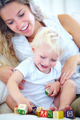 Buy stock photo Shot of a mother and her baby boy playing with building bplocks