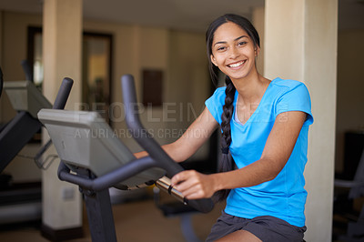 Buy stock photo Woman, portrait and exercise bike in gym, cycling and stationary machine for workout at club. Female person, cardio and cycling for strength training, smile and equipment for fitness and health