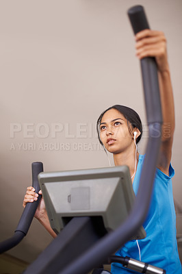 Buy stock photo Woman, earphones and audio for cycling, bike and stationary machine for workout at club. Female person, cardio and inspirational podcast for motivation, playlist and equipment for fitness and health
