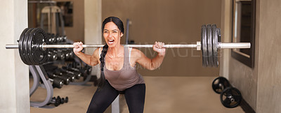 Buy stock photo Shot of a woman lifting a barbell with much difficulty in the gym