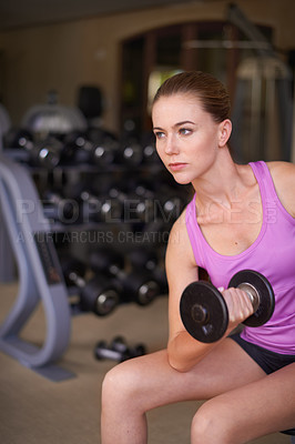 Buy stock photo Dumbbell, fitness and woman in a gym, workout and strength training with wellness and exercise with equipment. Thinking, serious face or girl in a health center and progress with weights or challenge