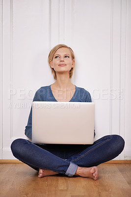 Buy stock photo Shot of a beautiful woman sitting on the floor using a laptop