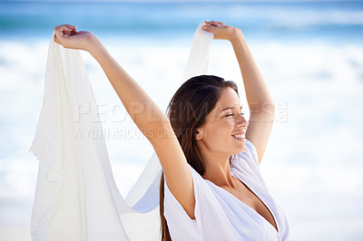 Buy stock photo Ocean, happy woman and fabric in wind at beach outdoor for summer, vacation and travel on holiday. Sea, smile and person fly with silk sarong in the air for adventure, freedom and breeze by water