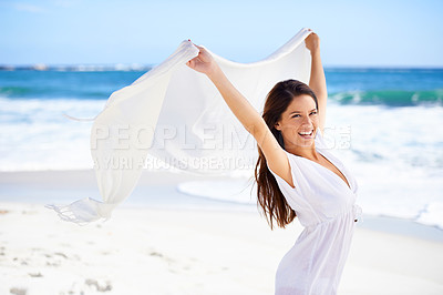 Buy stock photo Portrait, happy woman and fabric in wind at beach outdoor for summer, vacation and travel on holiday. Ocean, smile and person fly with scarf in the air for adventure, freedom and sea breeze by water