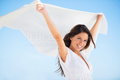Buy stock photo Portrait, smile and woman with sarong in wind outdoor for summer, vacation and travel on holiday. Face, happy person and fly with silk fabric in the air for freedom, beauty and breeze on blue sky