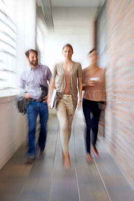 Buy stock photo Businesspeople, teamwork and walking in office with motion blur as colleagues for company, partnership or confident. Man, woman and corridor at startup with paperwork or deadline, speed or urgent