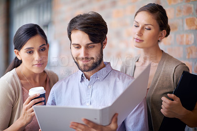 Buy stock photo Portfolio, teamwork and employees talking in office for planning, partnership or conversation. Man, women or people in group meeting for business, collaboration and speaking of file or reading folder