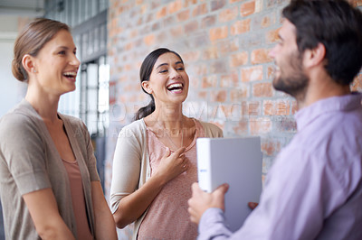 Buy stock photo Shot of a coworkers talking to each other in a office hallway