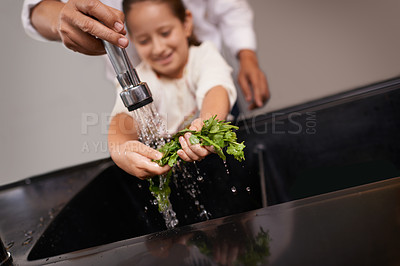 Buy stock photo Child, washing and kitchen sink with salad, food and cleaning for cooking in a home. Water, health and happy girl with herb and helping for lunch and meal together with youth and learning hygiene