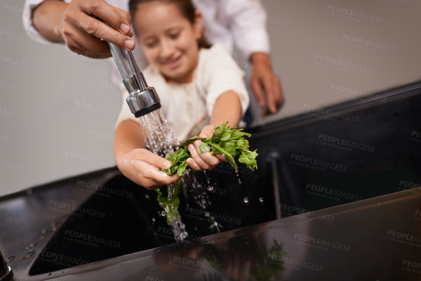 Buy stock photo Child, washing and kitchen sink with salad, food and cleaning for cooking in a home. Water, health and happy girl with herb and helping for lunch and meal together with youth and learning hygiene