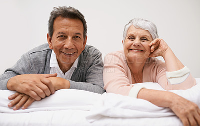 Buy stock photo Portrait, senior or happy couple in bed to relax in home or house for bonding or support together. Retirement, morning or face of a man with an elderly woman with smile, love or care in marriage