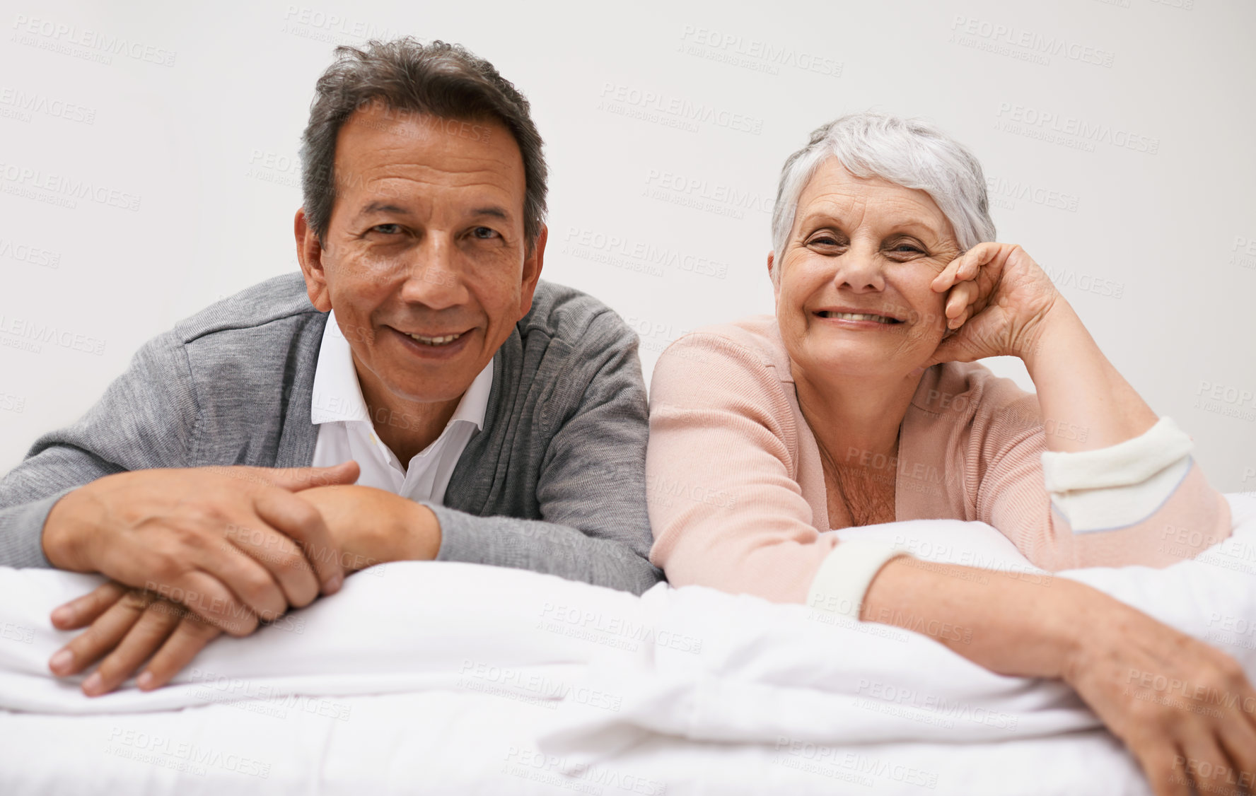 Buy stock photo Portrait, senior or happy couple in bed to relax in home or house for bonding or support together. Retirement, morning or face of a man with an elderly woman with smile, love or care in marriage