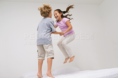 Buy stock photo Jumping, bed and kids with laugh, happy and morning in a bedroom with game and sibling. Youth, bonding and home with excited children in air with crazy, play and funny joke with energy and friends