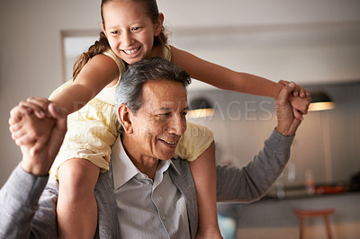 Buy stock photo Shot of a grandfather giving his little granddaughter a piggy back