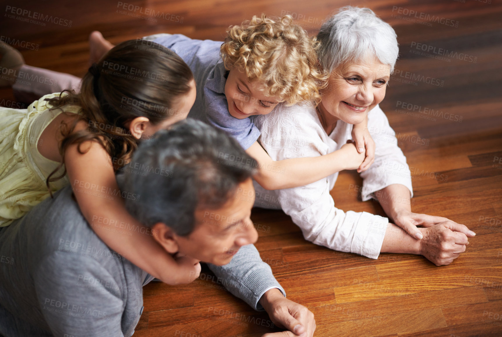 Buy stock photo Hug, floor or happy grandparents with children playing together in lovely family home in retirement. Senior grandma, piggyback or kids siblings relaxing or bonding to enjoy quality time with old man