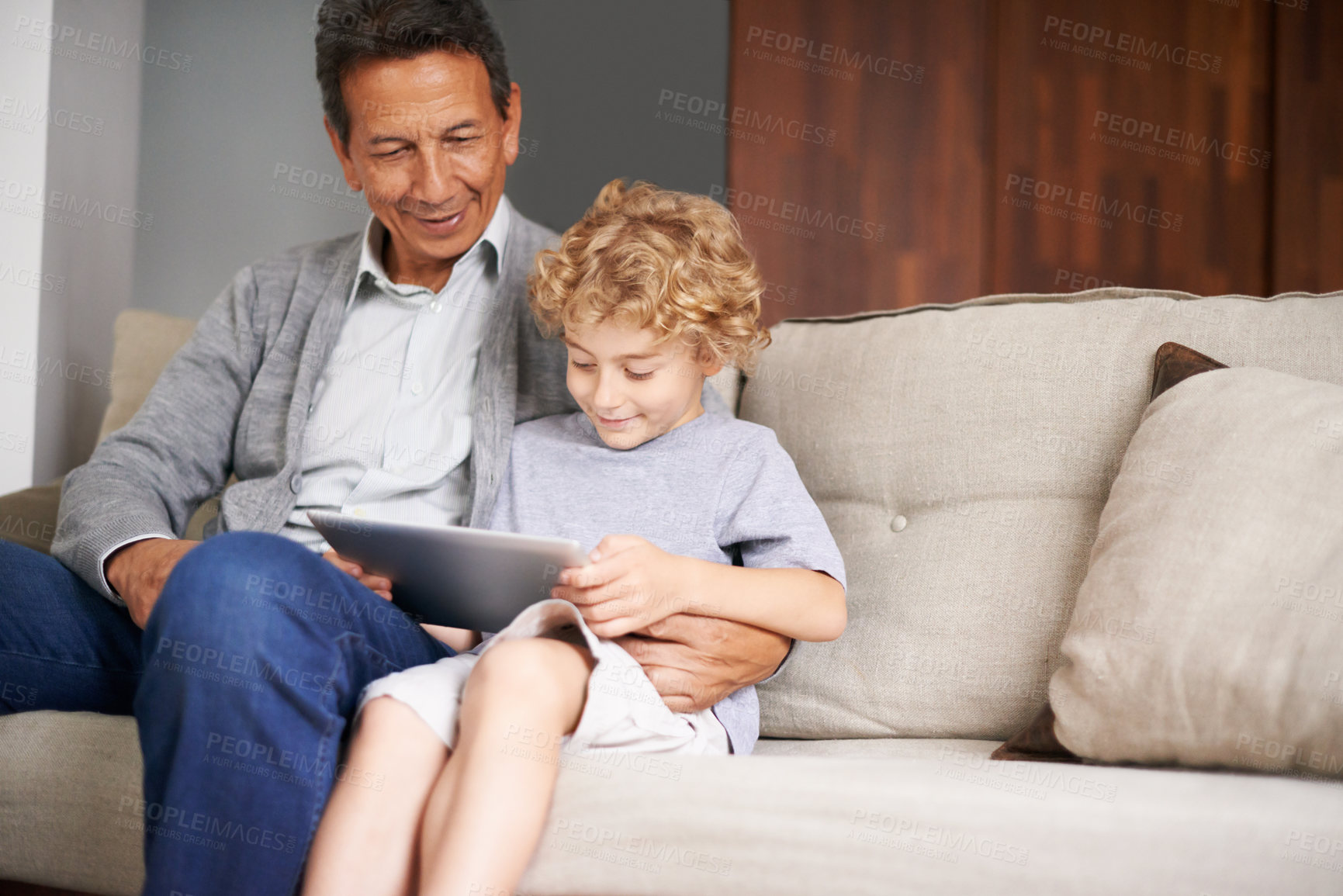 Buy stock photo Tablet, happy kid or grandfather streaming movie or film on online subscription in retirement at home to relax. Grandparent or child loves watching fun videos with a senior or mature old man on sofa