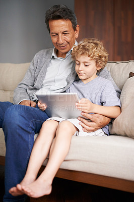 Buy stock photo Tablet, child or grandpa streaming movie or film on online subscription in retirement at home to relax. Family, grandfather or kid loves watching fun videos with a senior or mature old man on sofa 