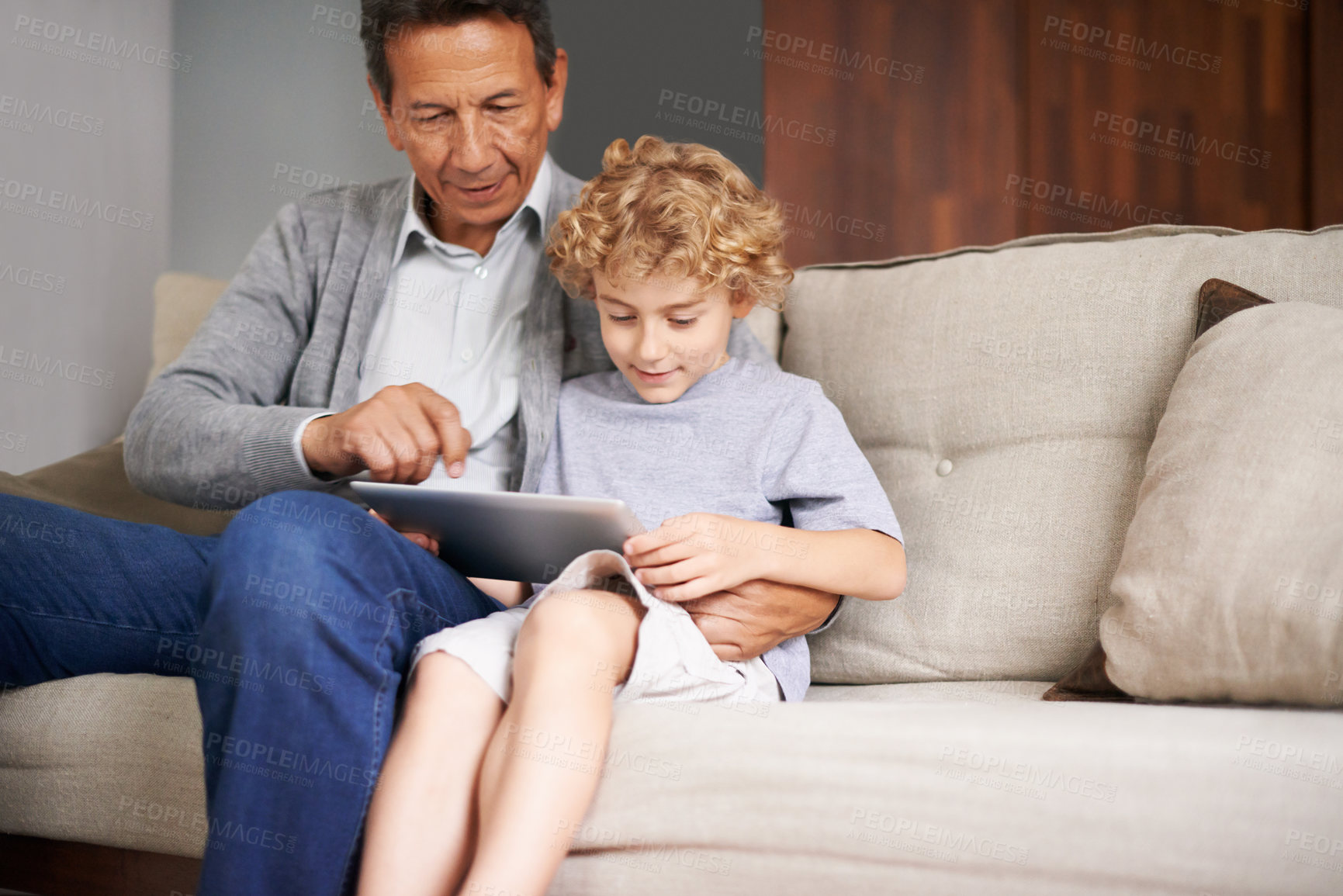 Buy stock photo Tablet, child or grandfather typing on online to search for games on internet in retirement at home to relax. Grandparent or young kid enjoying watching videos with a senior or mature old man on sofa