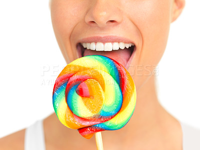 Buy stock photo Candy, lollipop and sweets with a woman in studio isolated on a white background eating a sweet snack. Food, bright or color with a young female holding and licking a giant lolly closeup alone