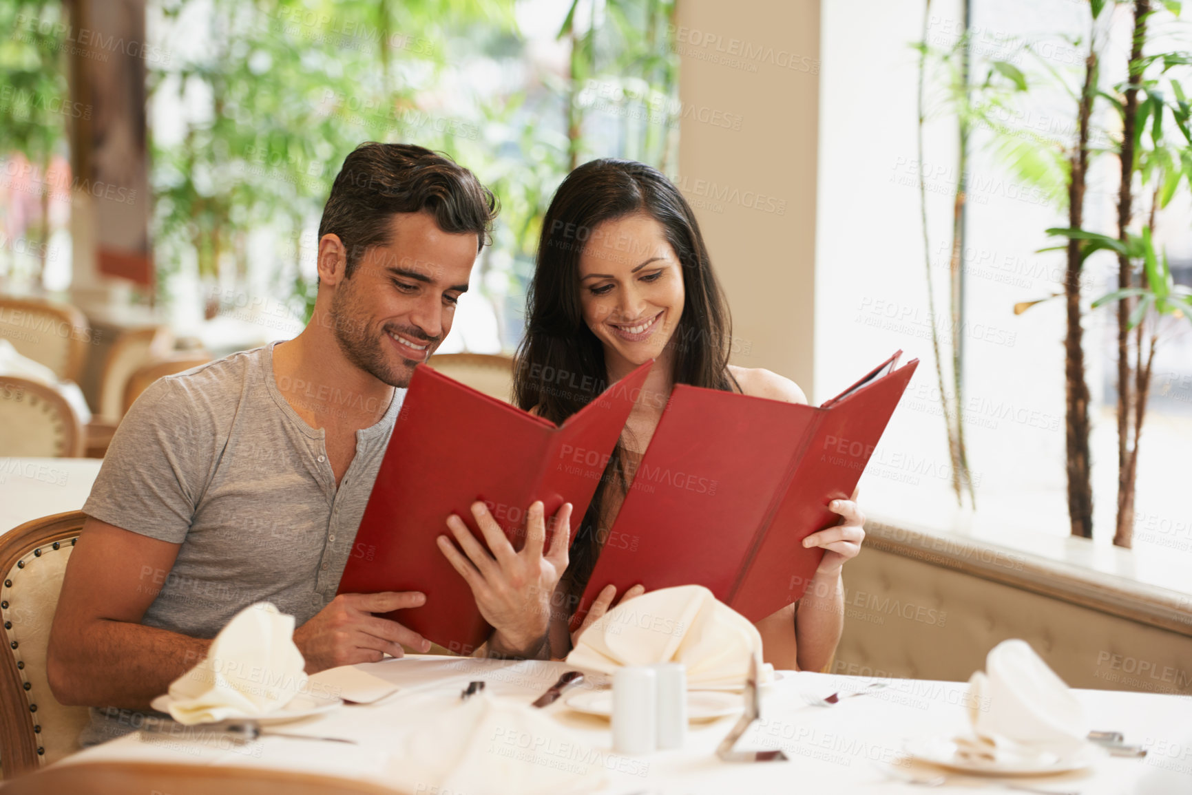 Buy stock photo Couple, restaurant and menu for choice, conversation and bonding on valentines day. People, love and romance at cafe or lunch selection at bistro, cuisine and happy in relationship or laugh for joke