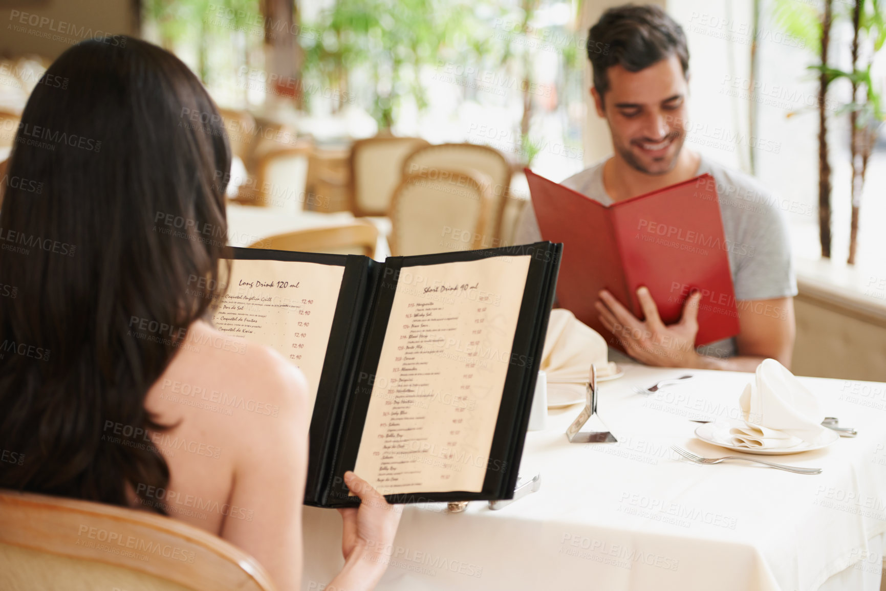 Buy stock photo Couple, restaurant and menu for food decision, fine dining and bonding on valentines day. People, love and romance at cafe or lunch choice for anniversary celebration, cuisine and happy at bistro
