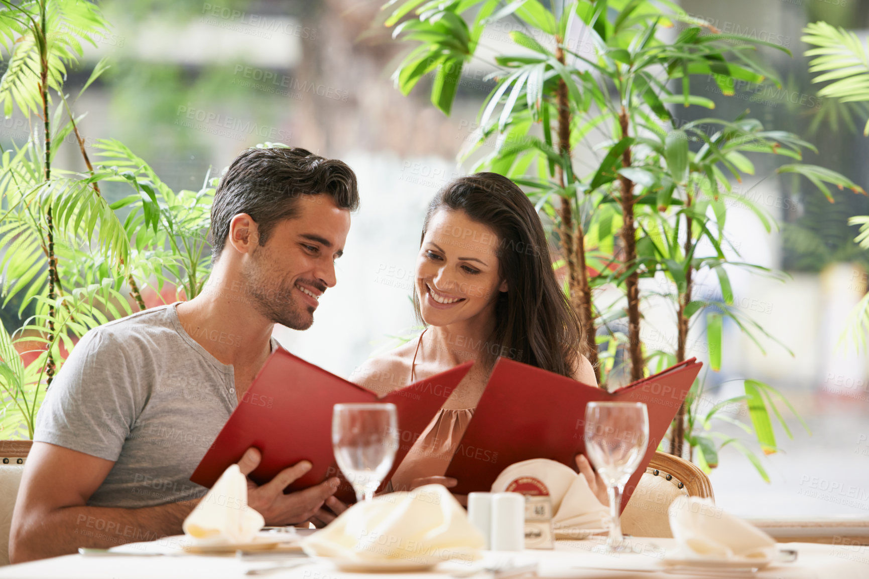 Buy stock photo Couple, restaurant and reading a menu on date, fine dining and bonding on valentines day. People, love and romance at cafe or lunch choice for anniversary celebration, cuisine and happy at bistro