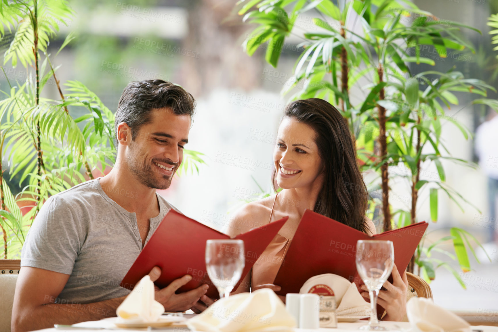 Buy stock photo A happy young couple on a date at a fancy restaurant
